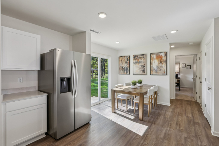A kitchen with a dining table.