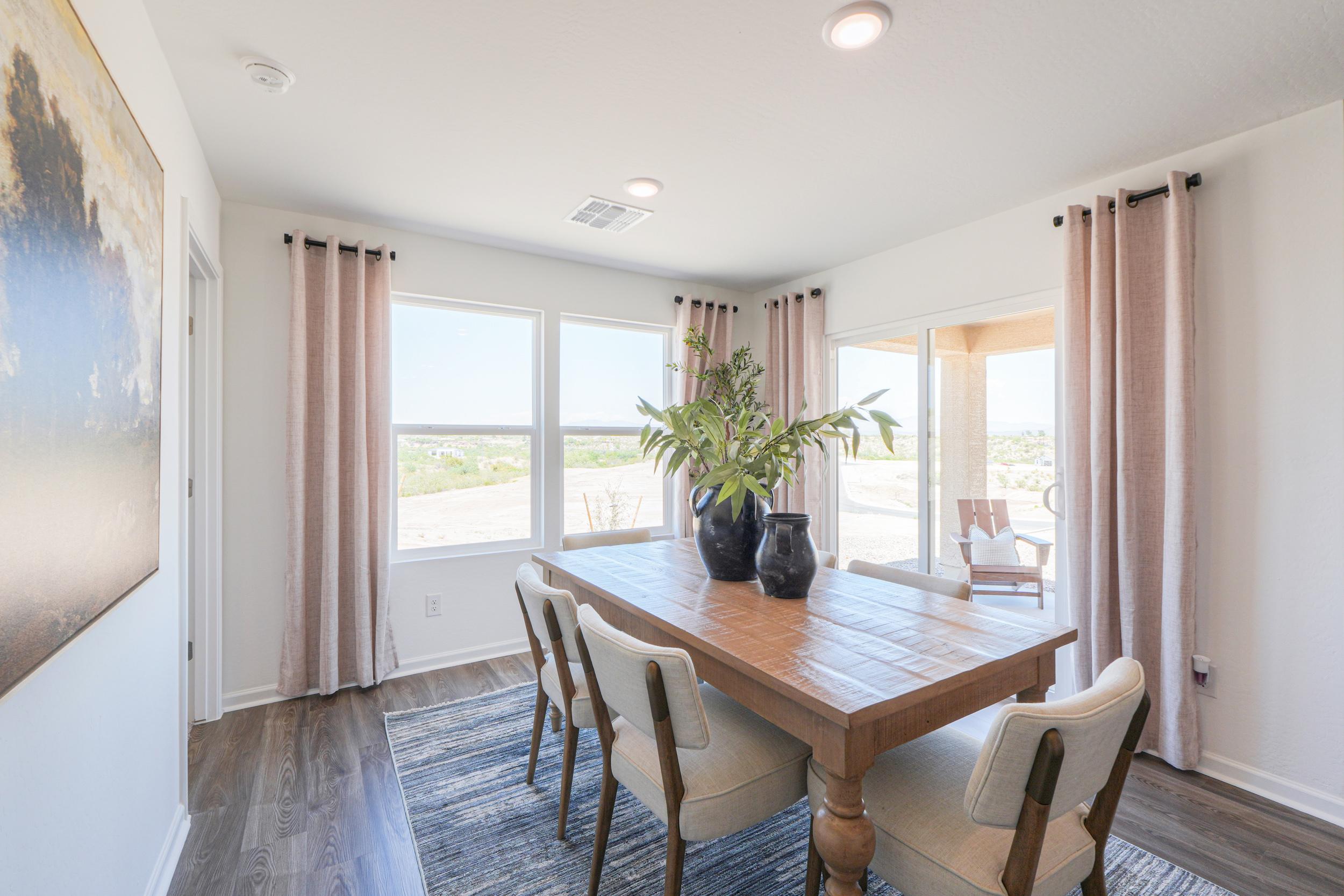 A dining room table with chairs.
