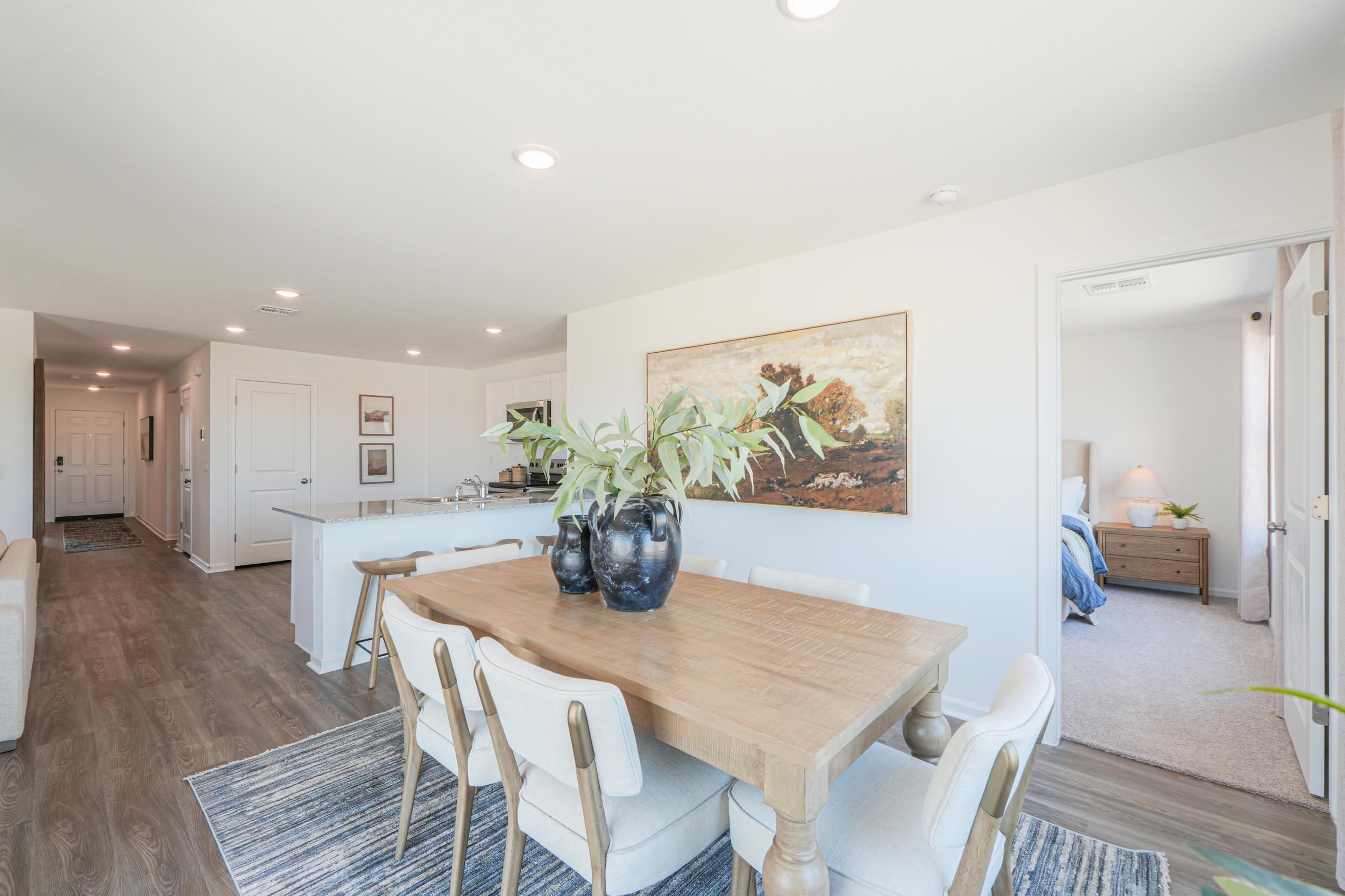 A dining room with a table and chairs.