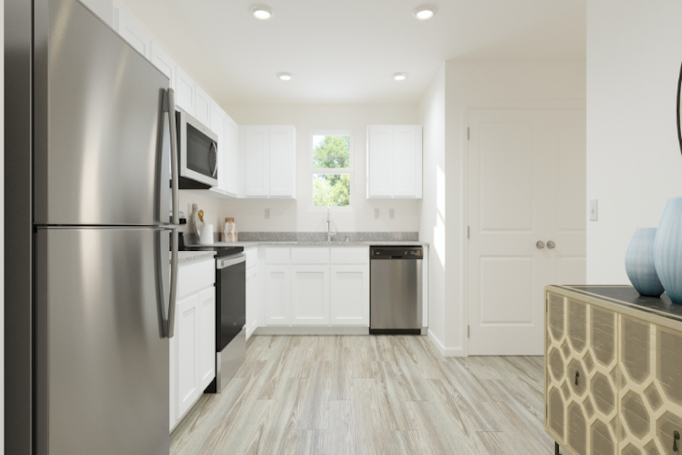 A kitchen with white cabinets.