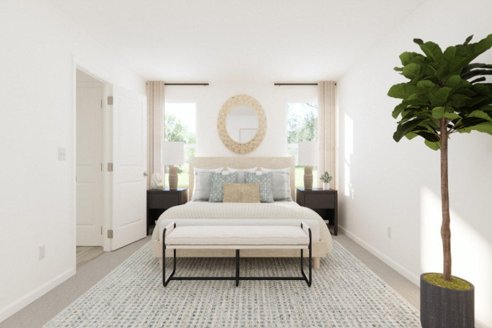 A bedroom with a bed and a table.