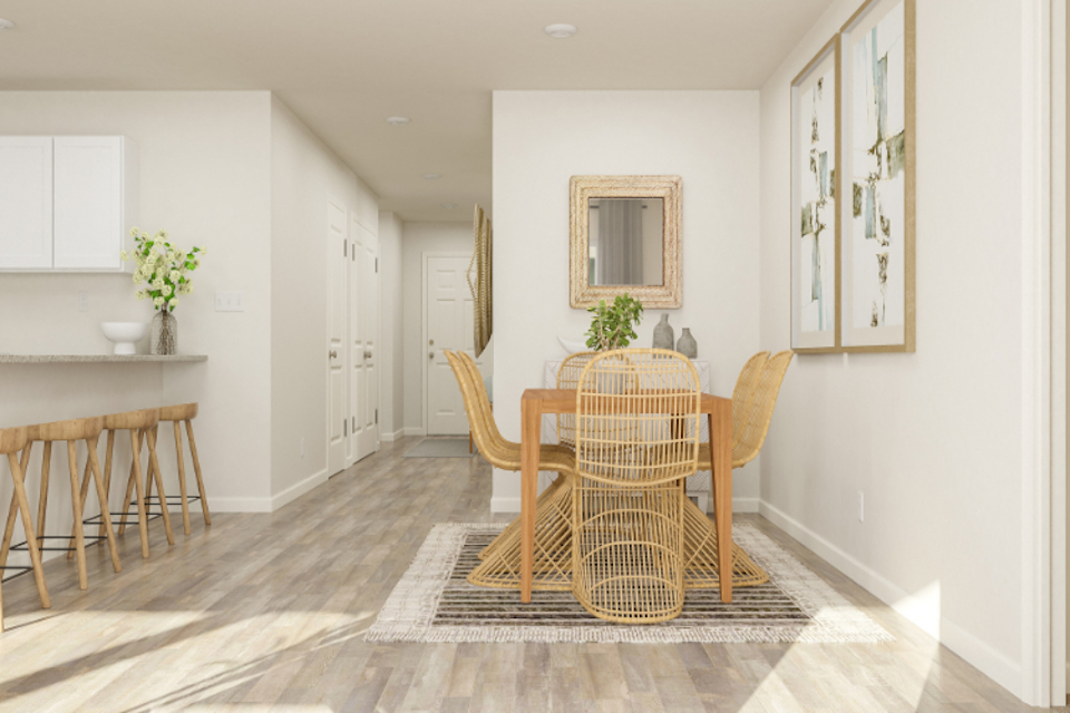 A dining room with a table and chairs.