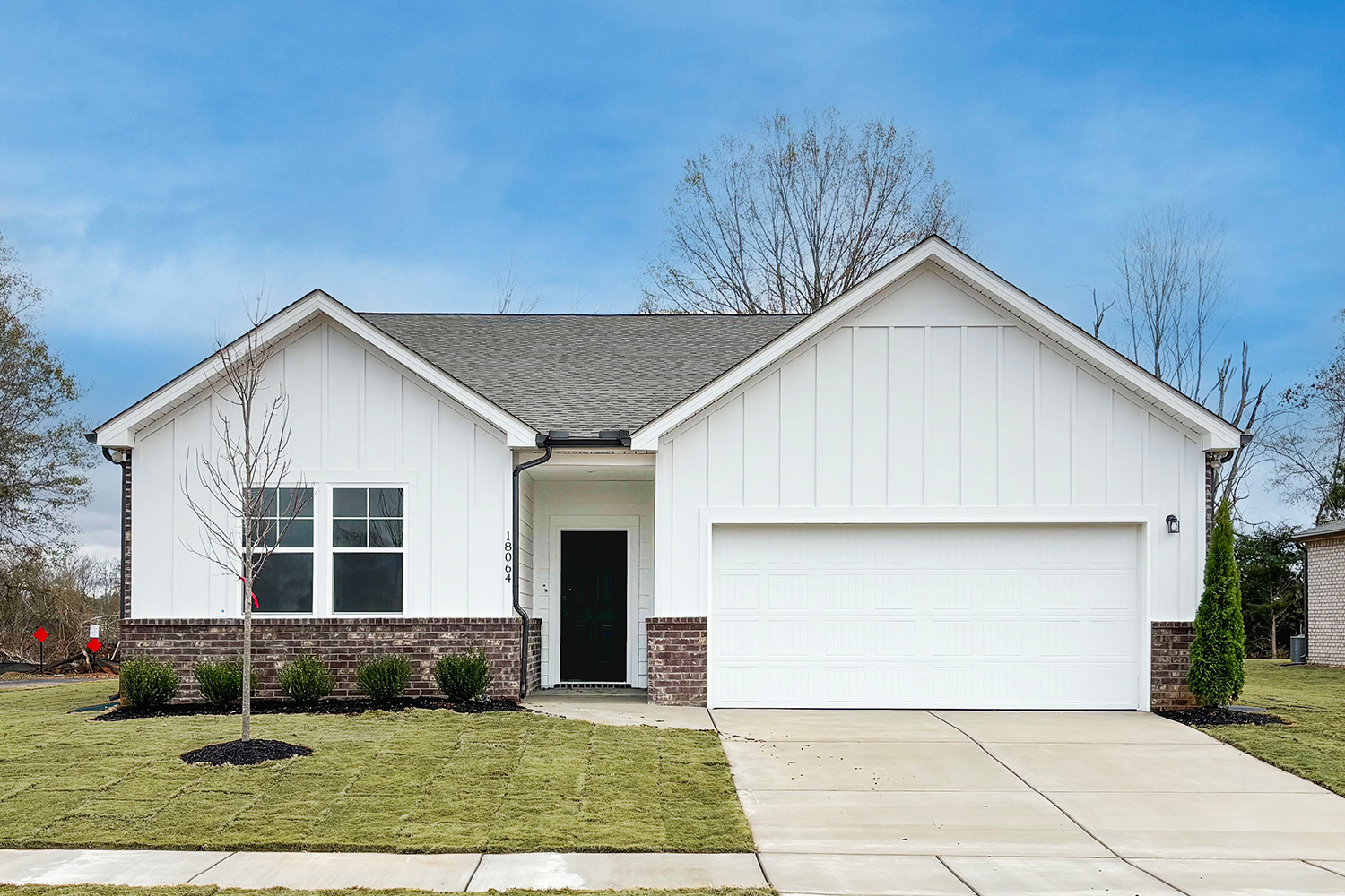 A white house with a garage.