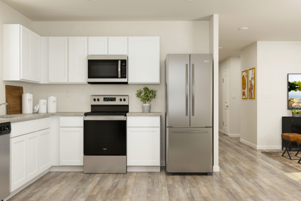 A kitchen with white cabinets.