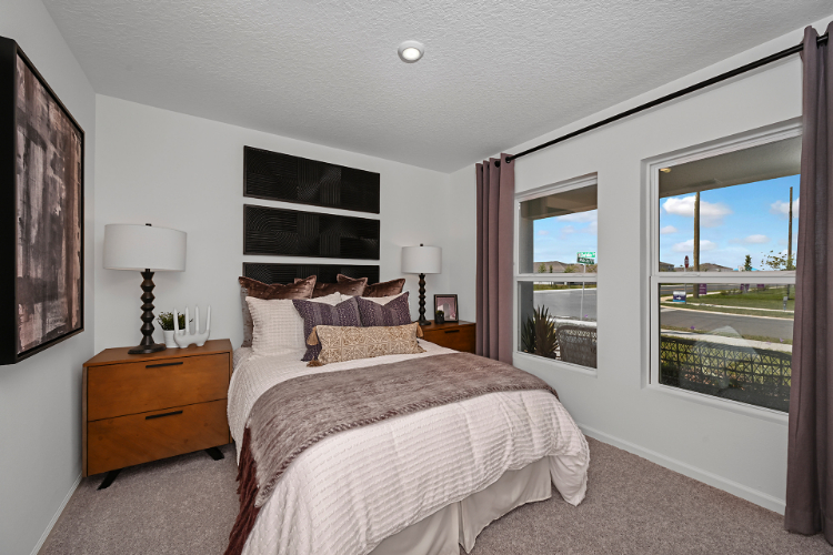 A bedroom with a large window.