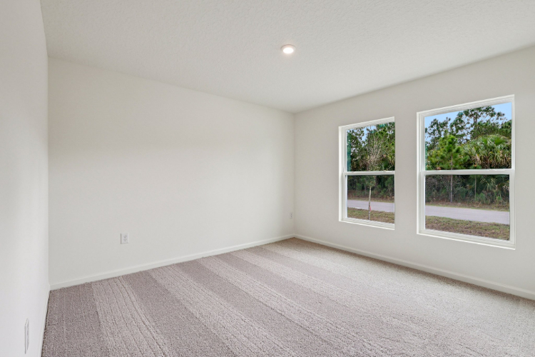 A room with a wood floor and windows.