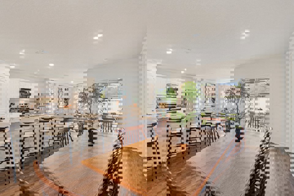 A large kitchen with a dining table.