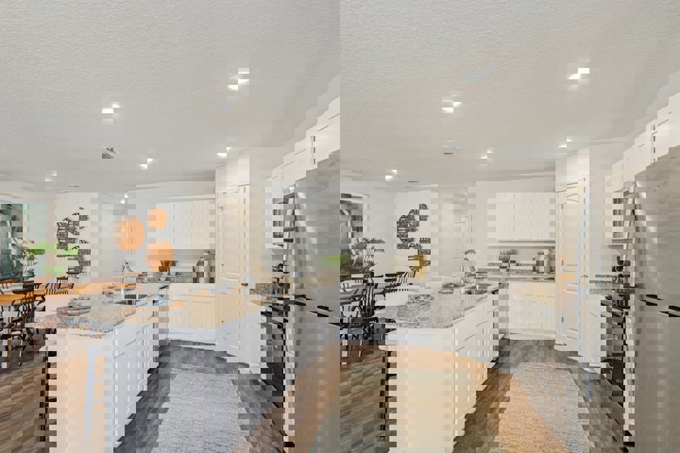 A kitchen with white cabinets.