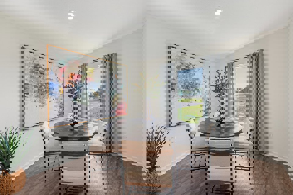 A dining room table with chairs.