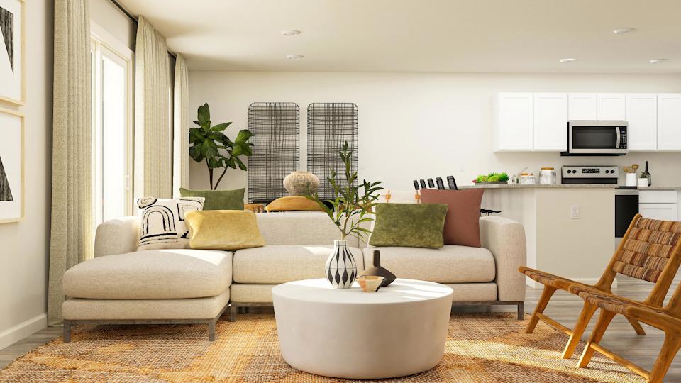A living room with a white couch and a table.