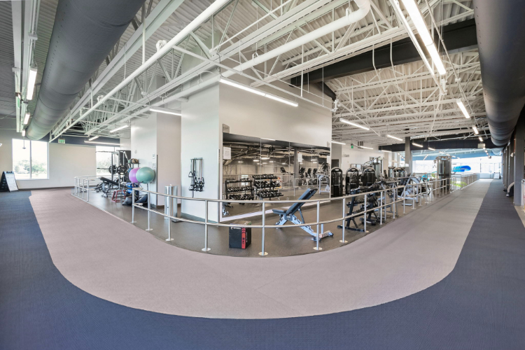 A large empty room with a few chairs and a few tables.