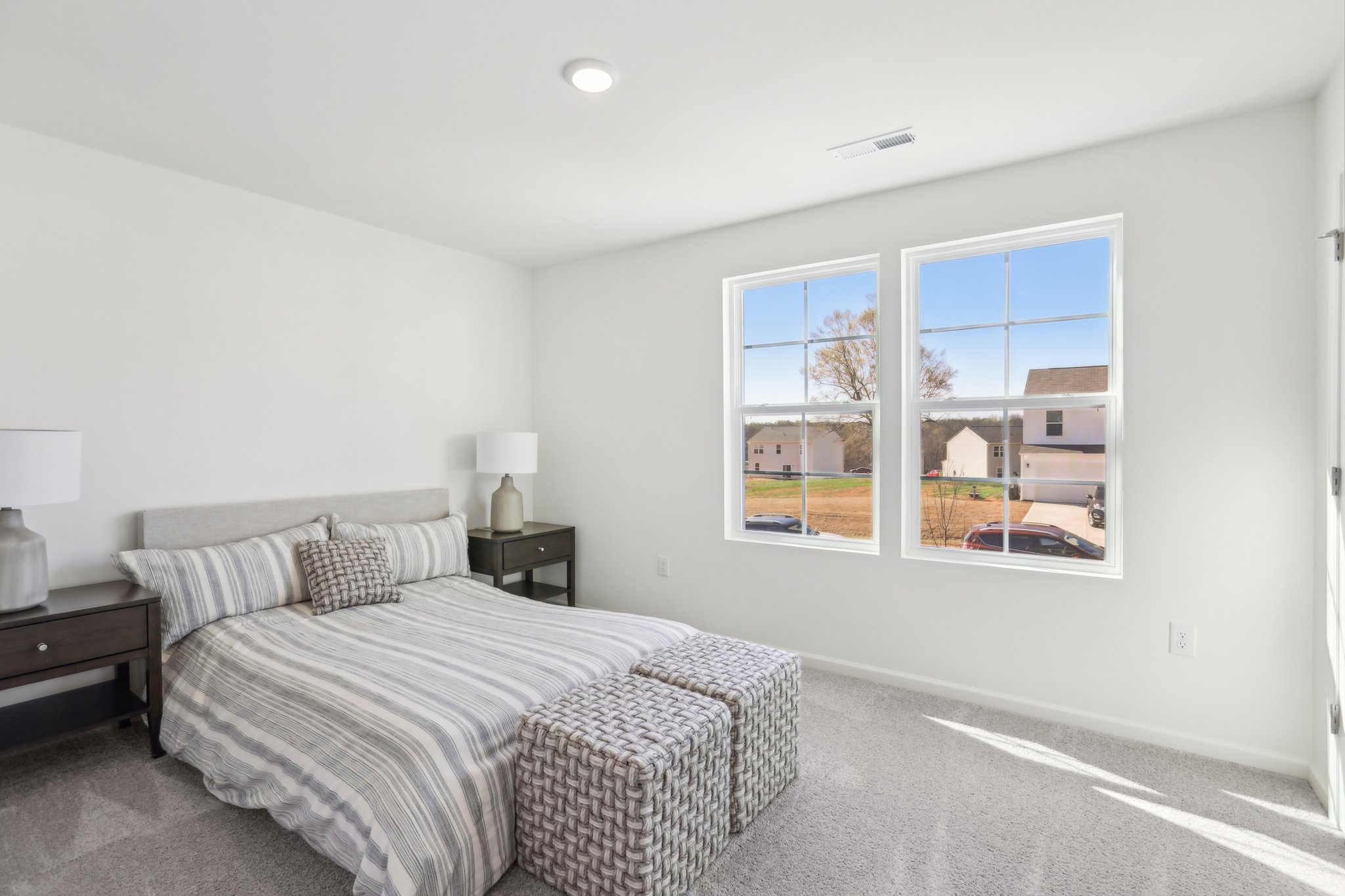 A bedroom with a bed and a window.