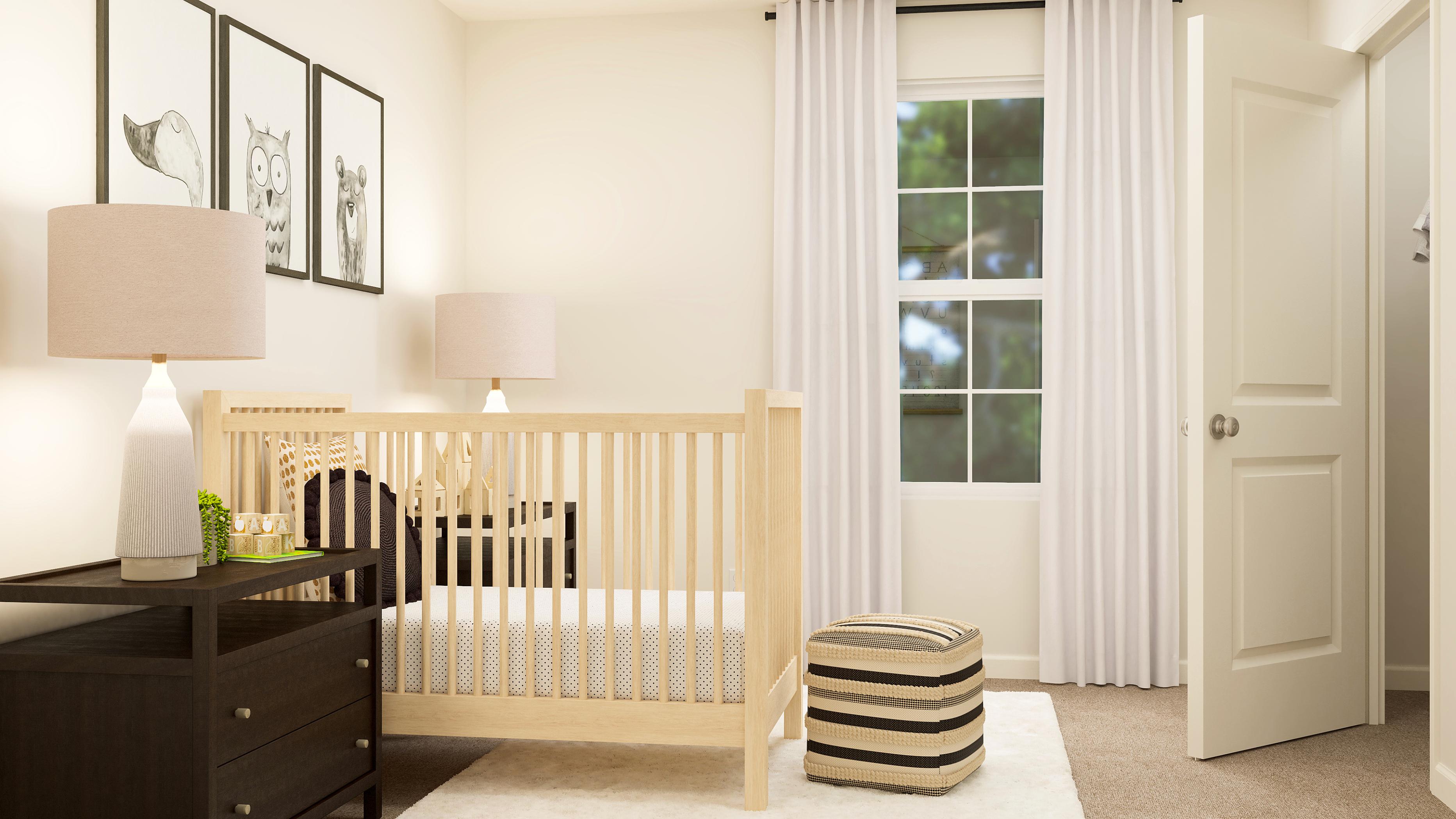 A white room with a white crib and a white door.