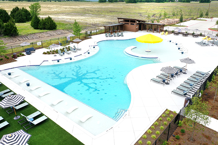A swimming pool with lounge chairs.